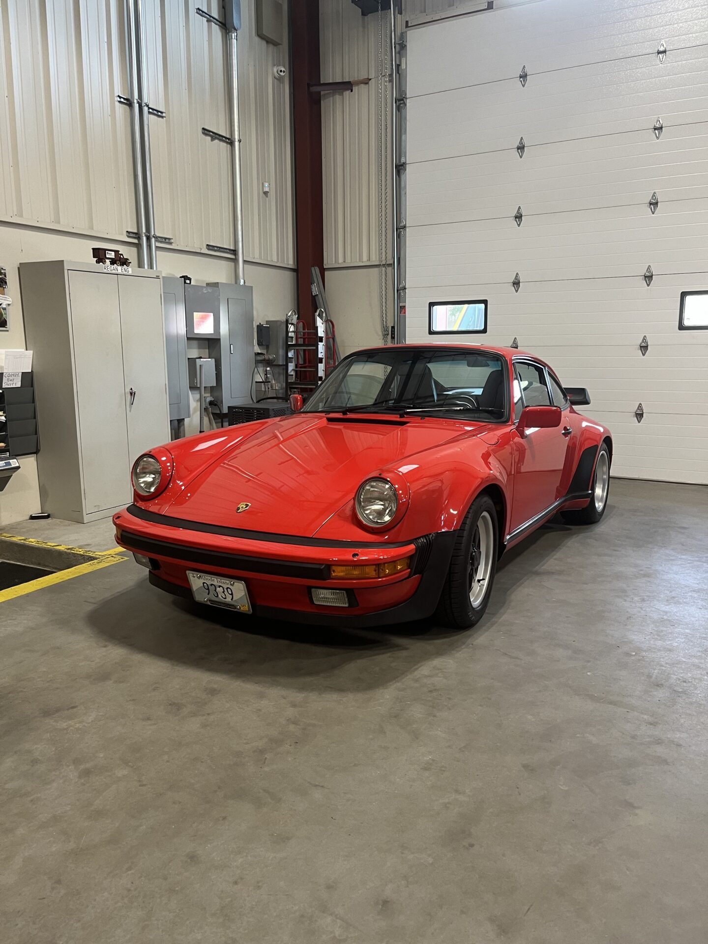 Red Porsche 911 Turbo after professional paint correction and ceramic coating at a Newport auto detailing shop.